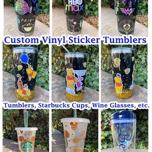 May include: Custom vinyl sticker tumblers, Starbucks cups, and wine glasses. The tumblers are black with gold glitter and feature Winnie the Pooh and Tigger designs. The Starbucks cups are clear with a Mickey Mouse design and orange glitter. The wine glass is clear with a blue lid and the name "Beth" written on it.