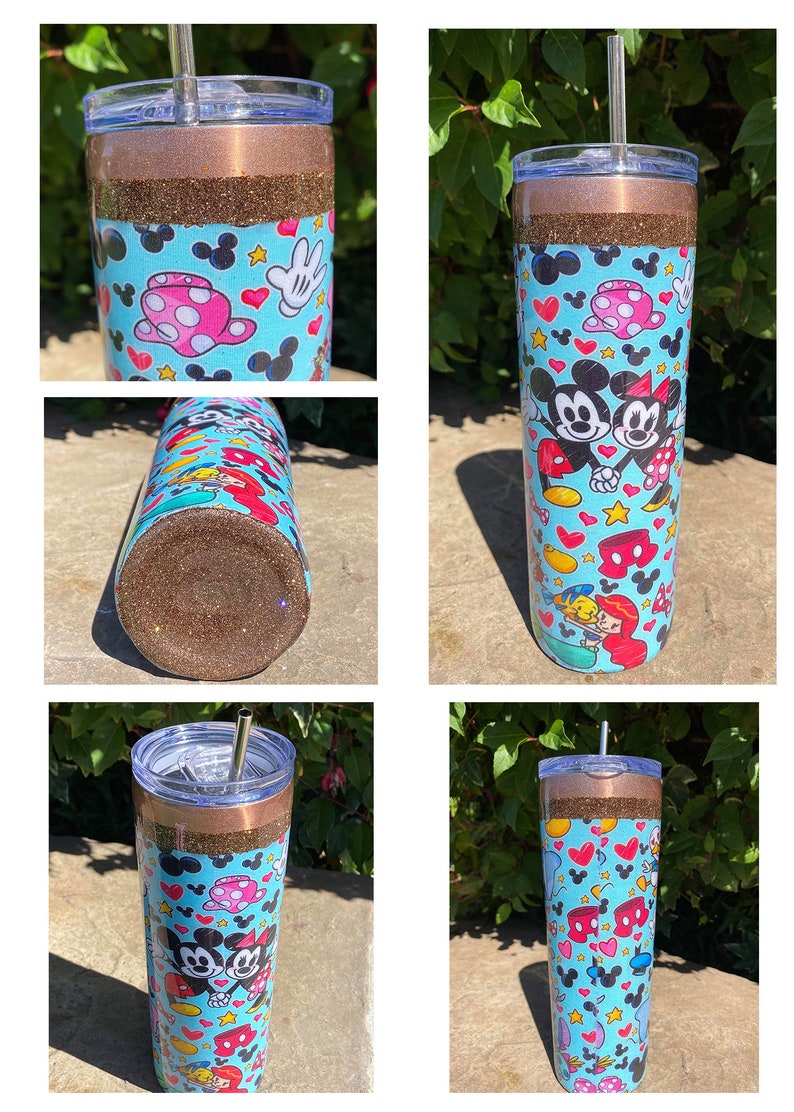 May include: A brown and gold glitter tumbler with a blue and white Mickey Mouse and Minnie Mouse design. The tumbler has a clear lid and a straw.