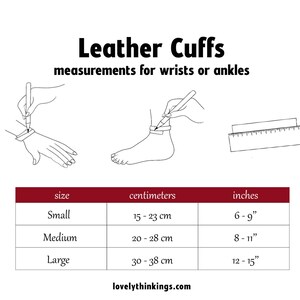 May include: A chart showing the size guide for leather cuffs in inches and centimeters. The chart shows the size, wrist or ankle measurement in centimeters, and the corresponding size in inches. Small is 15-23 cm or 6-9 inches, Medium is 20-28 cm or 8-11 inches, and Large is 30-38 cm or 12-15 inches.