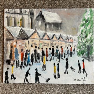 May include: An oil painting depicting a snowy winter scene with a market and people. The painting features a row of market stalls, a church, and a green tree. Figures in coats and hats walk in the snow. The color palette includes white, gray, black, and touches of color.
