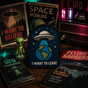 May include: A dark blue embroidered patch featuring a silver UFO hovering above a blue and green Earth, with the text I WANT TO LEAVE printed in white at the bottom. The patch has a rounded top edge and a black border, showcasing a space theme.