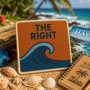 May include: A square patch with a rust-coloured background featuring a dark blue ocean wave graphic and the text THE RIGHT in dark blue lettering. The patch has a light tan stitched border and is displayed alongside a beach journal and sunglasses.