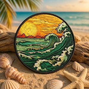 May include: Round embroidered patch featuring a sunset over the ocean with a large wave. The patch has a black border and is surrounded by seashells and a starfish on a sandy beach. The colors include shades of yellow, orange, green, and blue.