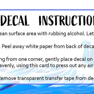 May include: A white rectangular sign with blue borders and a sailboat graphic. The sign reads "DECAL INSTRUCTIONS:" followed by four steps for applying a decal to a surface.