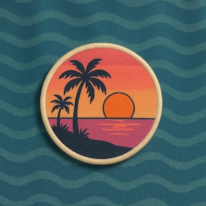 May include: Embroidered patch featuring a sunset scene with palm trees, a vibrant orange sun, and a pink and purple ocean. The patch has a beige border and is set against a teal, wavy background.