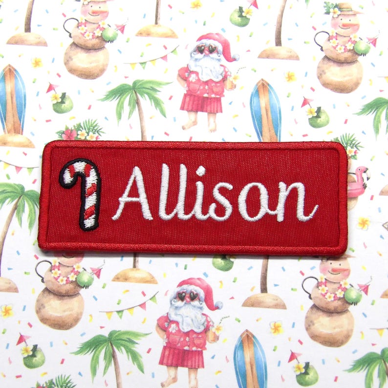 May include: Red rectangular embroidered patch with a white candy cane and the name "Allison" in white cursive lettering.