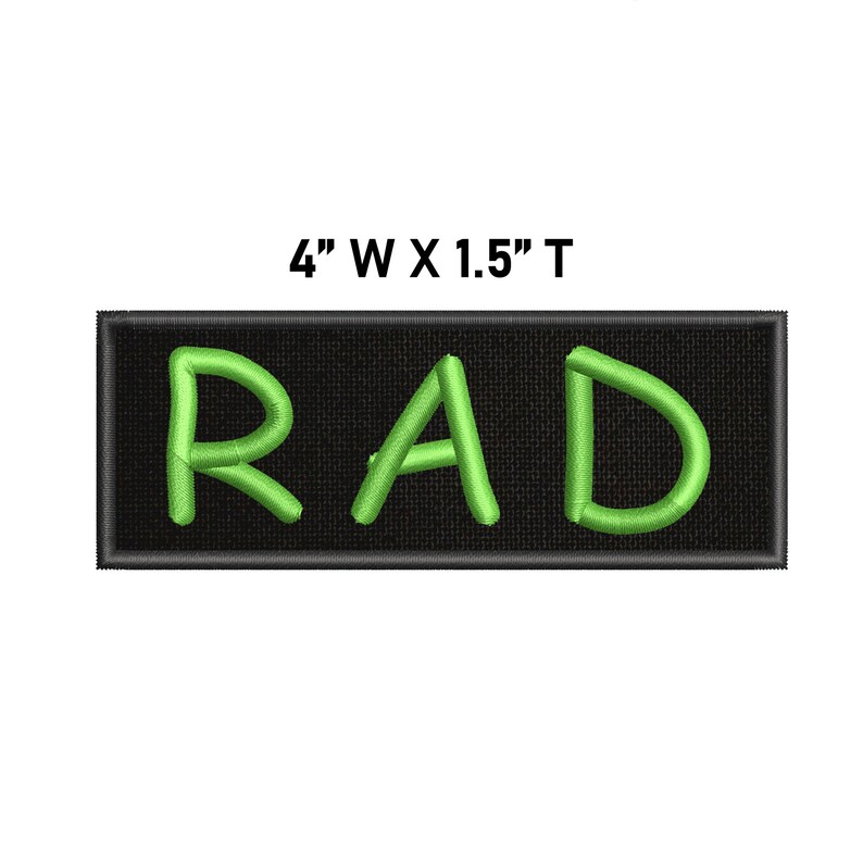 May include: A rectangular embroidered patch with a black background and the word RAD stitched in bright lime green thread. The patch features a black border and includes the printed text 4" W X 1.5" T above the design to indicate its dimensions.