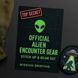 May include: A dark green card with the words "TOP SECRET" in a red rectangle. The card features a green alien head graphic and the text "OFFICIAL ALIEN ENCOUNTER GEAR". A patch with a UFO and a creature is also visible.