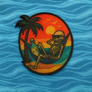 May include: Embroidered patch featuring a skeleton in sunglasses relaxing in a hammock on a beach. A palm tree and a bottle are next to the skeleton. The background shows a sunset with an orange and red sky, and the patch is circular.
