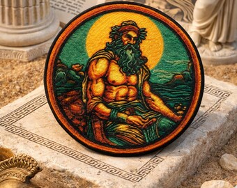 May include: A round embroidered patch featuring a seated, muscular figure with a long beard, laurel wreath, and flowing robes. The design includes a yellow sun, green background, and orange border. The patch is placed on a stone surface.