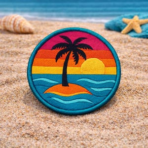 May include: Round embroidered patch depicting a tropical island scene. It features a black palm tree, yellow sun, and blue ocean waves against a sunset sky. The patch has a teal border, suitable for attaching to clothing or accessories.