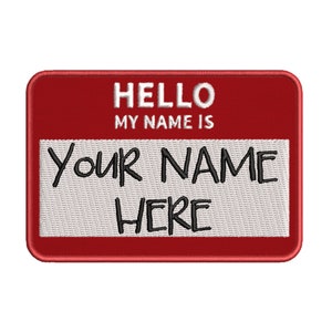 May include: Red name tag with white stitching and the text "HELLO MY NAME IS YOUR NAME HERE" in black.