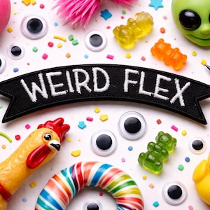 May include: A whimsical assortment of colorful toys and candies, including a rubber chicken, gummy bears, and a yellow duck wearing sunglasses. A black banner with the words "WEIRD FLEX" is prominently displayed. Scattered confetti adds to the playful scene.