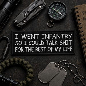 May include: A rectangular black embroidered patch featuring white text that reads: I WENT INFANTRY SO I COULD TALK SHIT FOR THE REST OF MY LIFE. The patch is surrounded by tactical gear including a flashlight, multi-tool, compass, notebook, carabiner, paracord bracelet, and dog tags.
