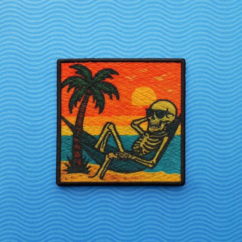 May include: Square patch featuring a skeleton relaxing in a hammock under a palm tree at sunset. The skeleton wears sunglasses and the background has orange, yellow, blue, and green colors. The patch has a black border.