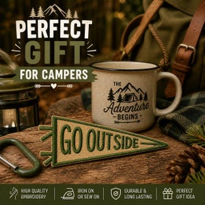 May include: A speckled ceramic camping mug with the text "The Adventure Begins" and a pennant patch that says "Go Outside." The image also includes a green carabiner and a backpack, suggesting a camping theme.