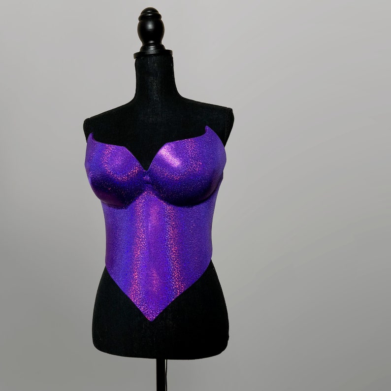 May include: Purple iridescent glitter corset top on a black dress form.