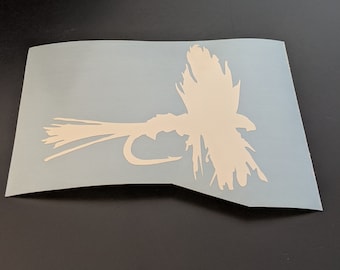 May include: White vinyl decal of a fly fishing lure on a light blue background.
