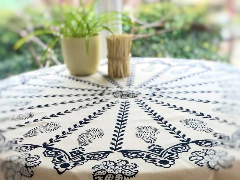 Handmade block printed round tablecloth featuring elegant black and white traditional pattern. The design showcases a striking sunburst medallion pattern with intricate floral and leaf motifs radiating from the center.