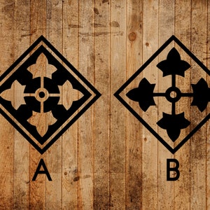 May include: Two black and white military insignia patches on a wood background. The patches are diamond shaped with a four-pointed star in the center and four stylized leaves around the star. The patches are labeled A and B.