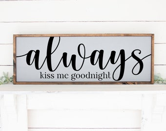 May include: A gray wooden sign with the text "always kiss me goodnight" in black cursive lettering.