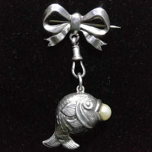 Silver bow and fish with pearl brooch
