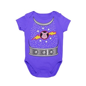 May include: Purple baby onesie with a silver and red space suit design featuring a pig head and lightning bolt. The onesie has a white star pattern.