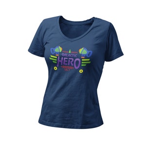 May include: A navy blue v-neck t-shirt with a colorful graphic design featuring the text "Galactic Hero" with a star and the text "+999999* LVL.7".
