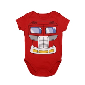 May include: Red baby onesie with a cartoon image of a red truck with yellow headlights and a gray grill.