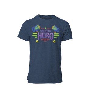 May include: A navy blue t-shirt with a graphic design of a spaceship and the text "GALACTIC HERO +999999+ LVL 7".