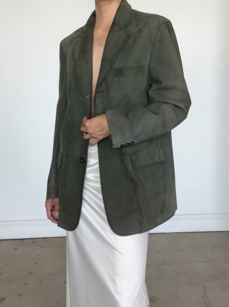 Vintage Sage green leather blazer with exposed stitching. Jacket has two front pockets.