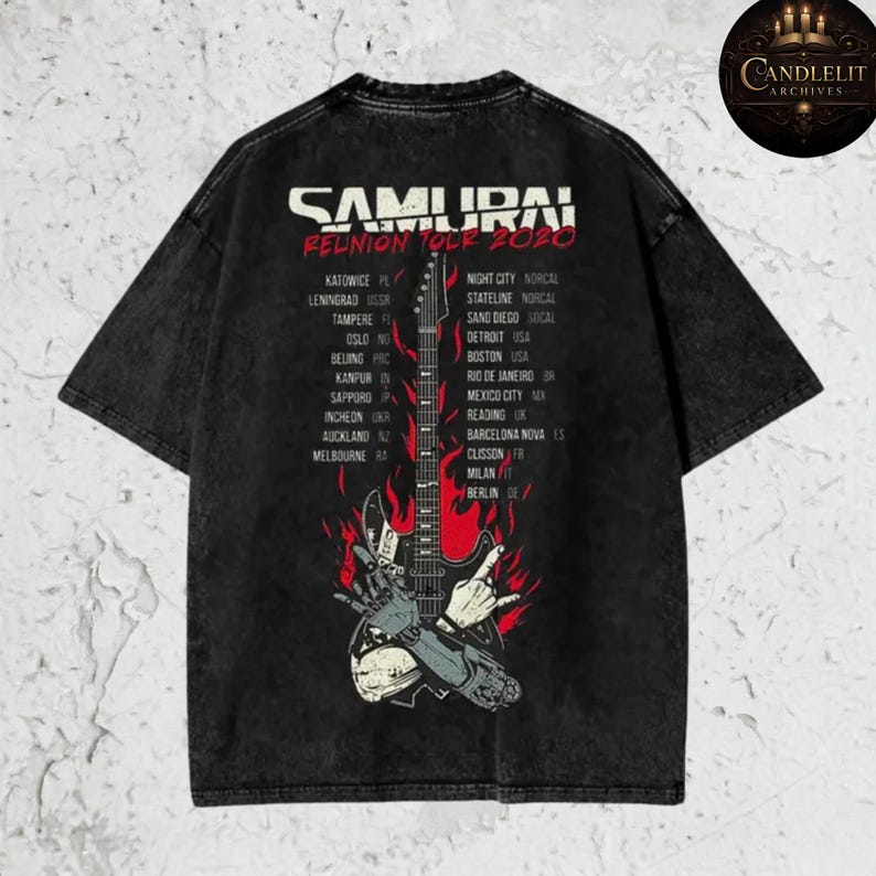 May include: Black t-shirt featuring the text "SAMURAI REUNION TOUR 2020" with a graphic of a guitar engulfed in flames. The shirt lists tour locations including Detroit, Boston, and San Diego.