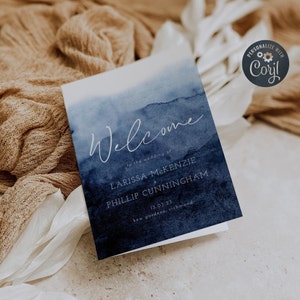 May include: A blue watercolor wedding welcome sign with the text "Welcome to the wedding of Larissa McKenzie & Phillip Cunningham 13.03.23 Kew Gardens, Richmond"