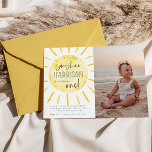 May include: A rectangular birthday invitation card featuring a yellow watercolor sun graphic with the text Our Little Sunshine Harrison Is Turning One, alongside a photograph of a toddler on a beach, paired with a mustard yellow envelope.