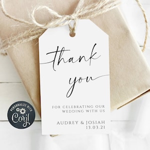 May include: White thank you gift tag with black calligraphy that says "Thank you" and the text "For celebrating our wedding with us Audrey & Josiah 13.03.21".
