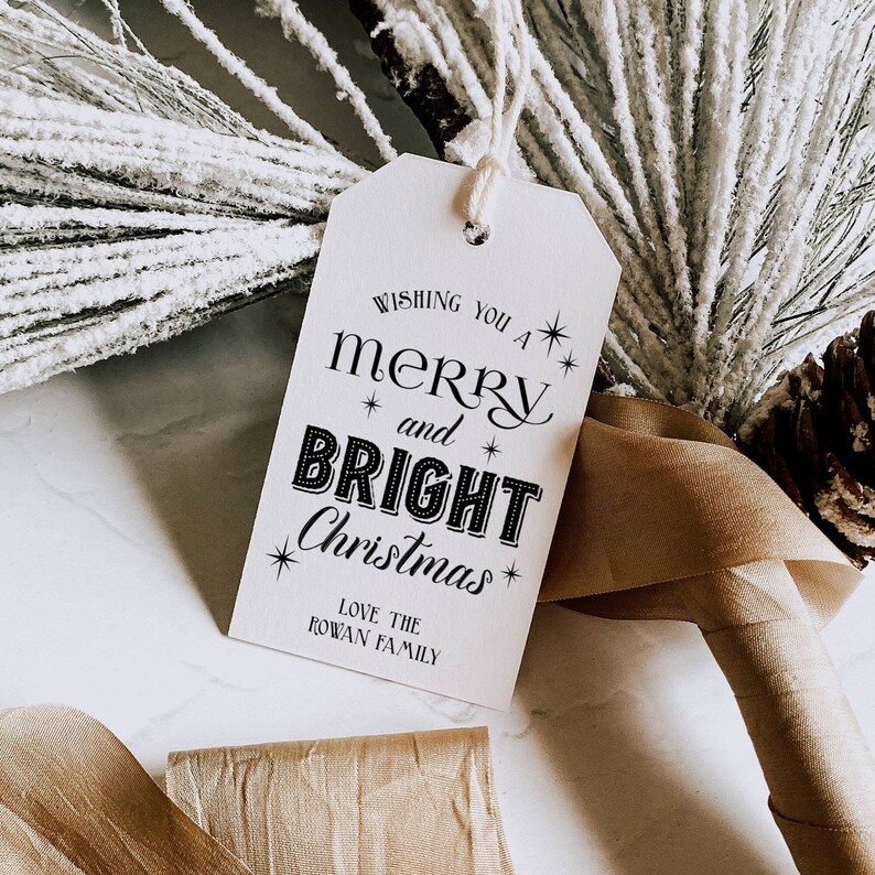 May include: White gift tag with black text that reads "Wishing you a merry and bright Christmas".  The text "Love the Rowan Family" is printed below the main message.