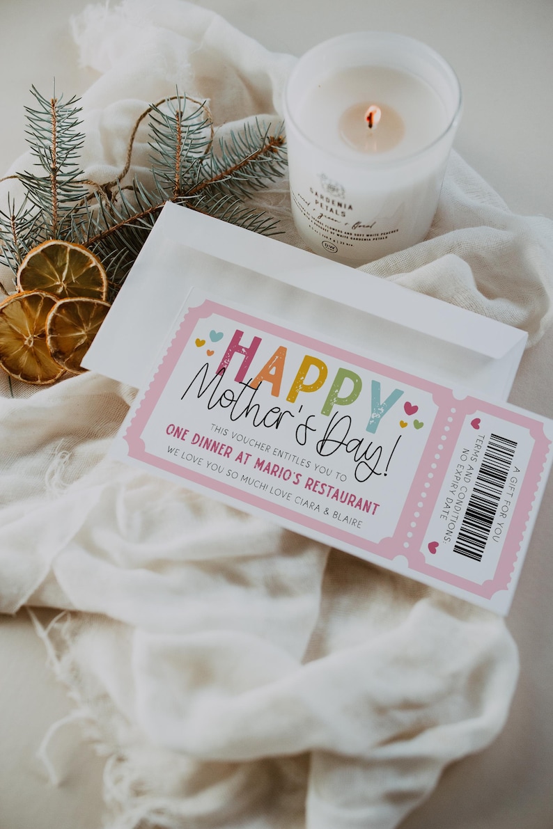 May include: A pink and white gift certificate with the text "Happy Mother's Day!" in colorful letters. The certificate is for one dinner at Mario's Restaurant. The text "This voucher entitles you to one dinner at Mario's Restaurant. We love you so much! Love Ciara & Blair" is printed on the certificate.