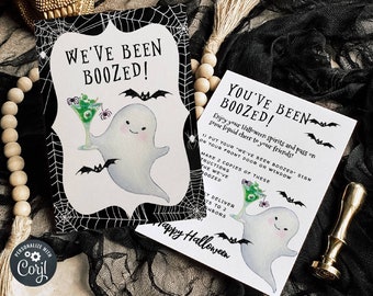 May include: Two printable Halloween signs featuring a ghost holding a green drink with a spider and bats. The text on the signs reads "We've Been Boozed!" and "You've Been Boozed! Enjoy your Halloween spirits and pass on some liquid cheer to your friends!"
