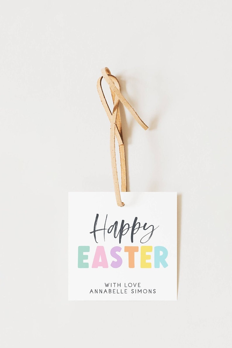 May include: A white gift tag with a brown leather string. The tag says "Happy Easter" in black script with the word "Easter" in colorful block letters. The tag also says "With Love Annabelle Simons".
