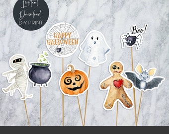 Peut inclure: Ensemble de 8 toppers de cupcake d'Halloween imprimables représentant un fantôme, une araignée, une citrouille, une momie, un chaudron, un bonhomme en pain d'épices, une chauve-souris et une toile d'araignée avec le texte "Happy Halloween".