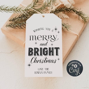 May include: White gift tag with black text that reads "Wishing you a merry and bright Christmas."  The tag also includes the text "Love the Rowan Family" and a black circle with the text "Personalize with Caryl" and a gear icon.