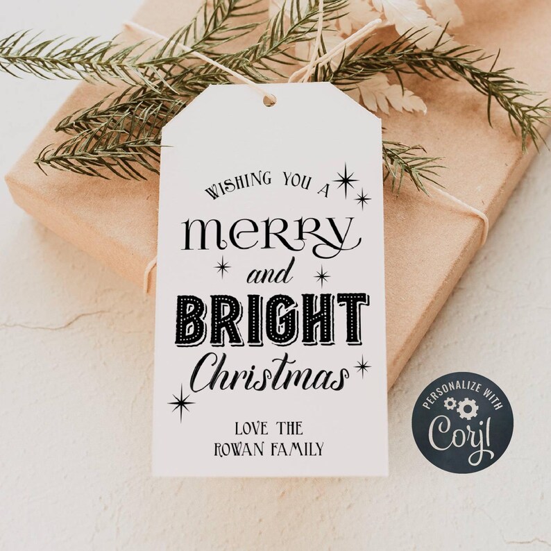 May include: White gift tag with black text that reads "Wishing you a merry and bright Christmas."  The tag also includes the text "Love the Rowan Family" and a black circle with the text "Personalize with Caryl" and a gear icon.