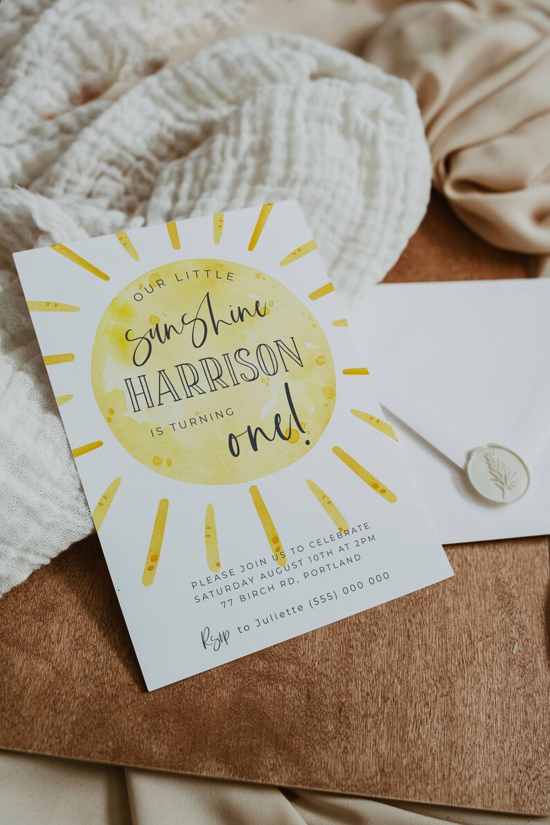 May include: A yellow and white birthday invitation with a sun illustration and the text "Our Little Sunshine Harrison is turning one!"  Please join us to celebrate Saturday August 10th at 2pm 77 Birch Rd, Portland RSVP to Juliette (555) 000 0000