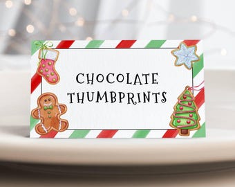 May include: A white card with red and green stripes. The card has the text "CHOCOLATE THUMBPRINTS" and images of gingerbread cookies, a stocking, a snowflake, and a Christmas tree.