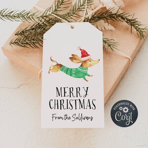 May include: White gift tag with a cartoon dachshund wearing a green sweater and a red Santa hat. The tag says "Merry Christmas" and "From the Sullivans".