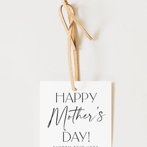 May include: White gift tag with black text that reads "Happy Mother's Day!" and "CUSTOM TEXT HERE". The tag is attached to a brown leather cord.