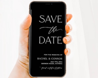May include: A smartphone displaying a black digital Save the Date card with white text that reads: SAVE the DATE FOR THE WEDDING OF RACHEL & CONNOR JULY 7TH, 2024 BARWON HEADS, VICTORIA formal invitation to follow. The device has a thin gold frame.