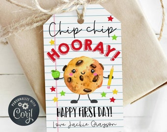 May include: A white gift tag with red and green stars, a smiling cartoon cookie holding an apple and a pencil, and the text "Chip chip hooray! Happy first day! Love Jackie Grayson".