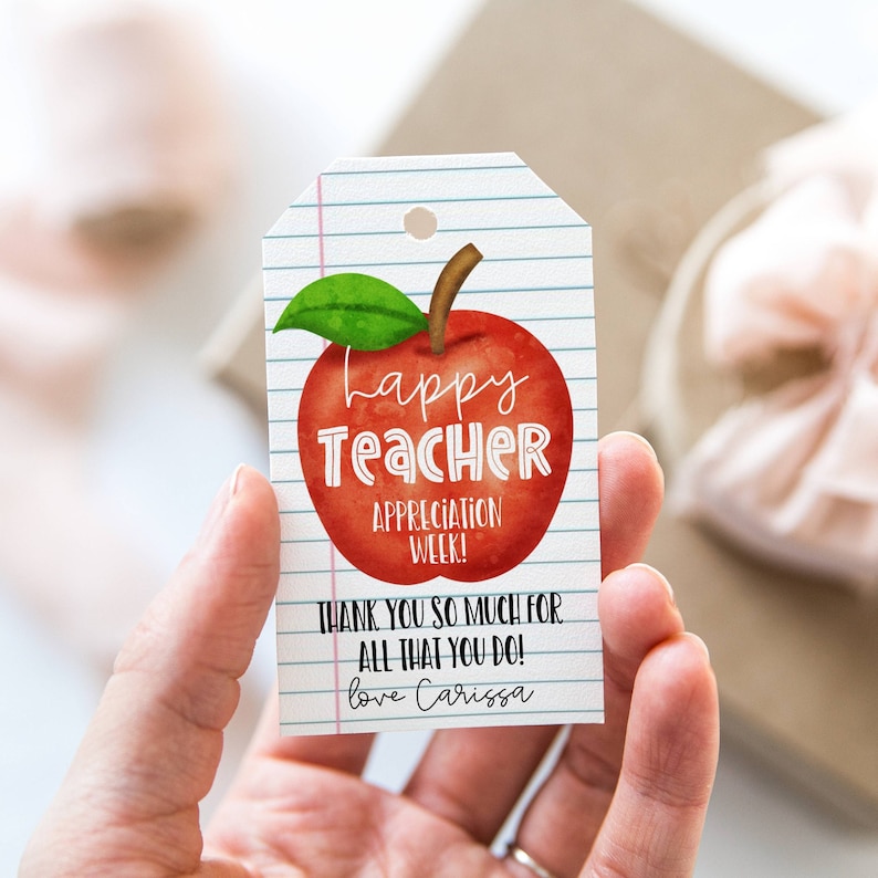 May include: A red apple with a green leaf on a white background with blue lines. The apple has the words "Happy Teacher Appreciation Week!" written on it. The text below the apple says "Thank you so much for all that you do! Love Carissa".