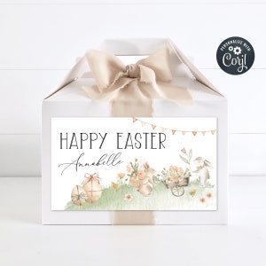 May include: White gift box with a beige ribbon and a personalised label that says "Happy Easter Annabelle". The label features a watercolour illustration of bunnies, flowers, and Easter eggs.